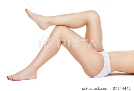 Studio shot of young well shaped woman with a beautiful body laying on white background 87344441