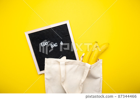 Eco bag on yellow background top view. 87344466