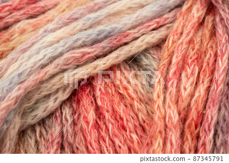 The Netherlands, February 2022. Close up of colored wool on a white background. The Netherlands, February 2022. Close up of colored wool on a white background. 87345791