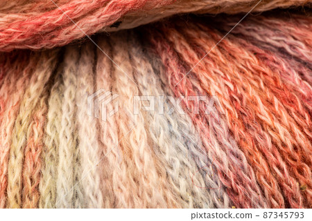 The Netherlands, February 2022. Close up of colored wool on a white background. The Netherlands, February 2022. Close up of colored wool on a white background. 87345793