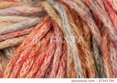The Netherlands, February 2022. Close up of colored wool on a white background. The Netherlands, February 2022. Close up of colored wool on a white background. 87345794