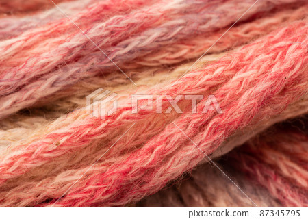 The Netherlands, February 2022. Close up of colored wool on a white background. The Netherlands, February 2022. Close up of colored wool on a white background. 87345795