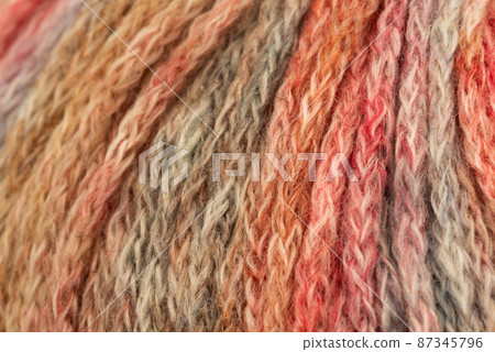 The Netherlands, February 2022. Close up of colored wool on a white background. The Netherlands, February 2022. Close up of colored wool on a white background. 87345796