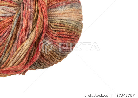 The Netherlands, February 2022. Close up of colored wool on a white background. The Netherlands, February 2022. Close up of colored wool on a white background. 87345797