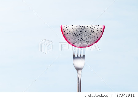 Sliced dragon fruit or pitaya on fork ready to eating, Tropical fruit Sliced dragon fruit or pitaya on fork ready to eating, Tropical fruit 87345911