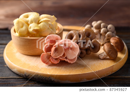 Mixed fresh mushroom (Edible mushroom) on wooden board prepare for cooking 87345927