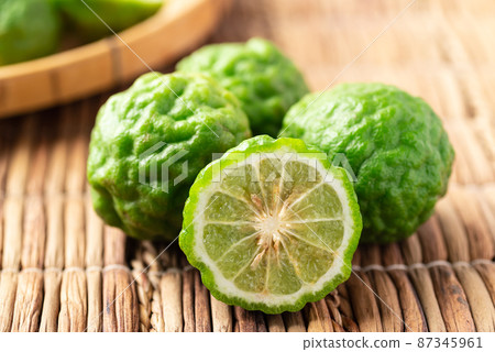Organic Kaffir lime, Citrus fruit used in Southeast Asian cuisine and essential oil Organic Kaffir lime, Citrus fruit used in Southeast Asian cuisine and essential oil 87345961
