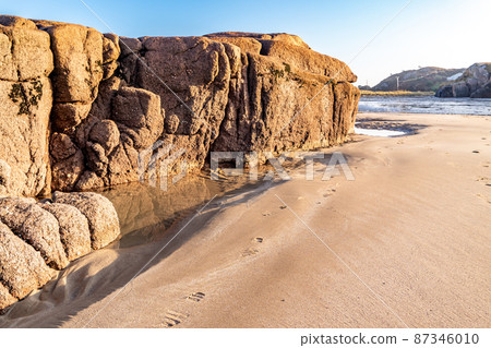 The beautiful stones at Cloughglass bay and beach by Burtonport in County Donegal - Ireland The beautiful stones at Cloughglass bay and beach by Burtonport in County Donegal - Ireland 87346010