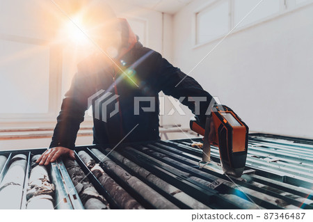 A special team of geologists who study rocks in industry using modern machines.Selective focus  87346487