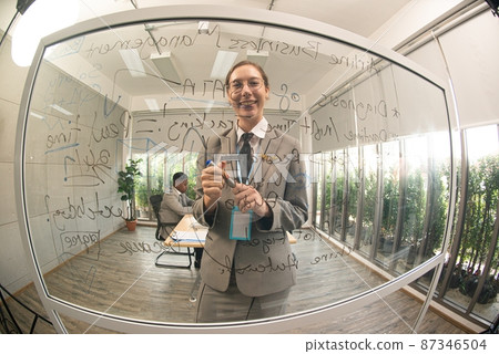 Woman in flying uniform standing at chalk board To explain to the coworkers how to work. Woman in flying uniform standing at chalk board To explain to the coworkers how to work. 87346504