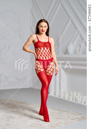 Pretty woman in fishnet full body stockings bodysuit 87346661