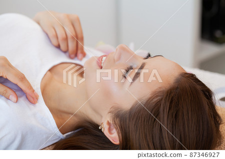 Beautiful girl has a facial massage in a beauty clinic. Beautiful girl has a facial massage in a beauty clinic. 87346927