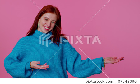 Girl pointing empty place, advertising area for commercial text, copy space for goods promotion Girl pointing empty place, advertising area for commercial text, copy space for goods promotion 87348096