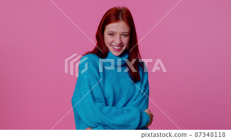 Cheerful lovely teenager student girl fashion model in blue sweater smiling and looking at camera Cheerful lovely teenager student girl fashion model in blue sweater smiling and looking at camera 87348118
