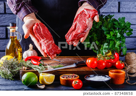 male chef holds chuck eye beef steak 87348658