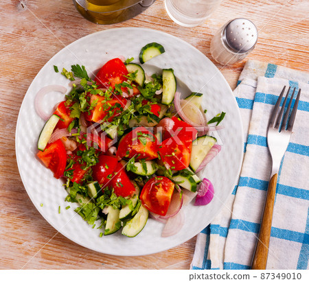 Appetizing cucumber and tomato salad closeup Appetizing cucumber and tomato salad closeup 87349010