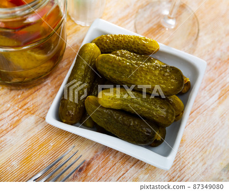 Pile of pickled cucumbers served on table Pile of pickled cucumbers served on table 87349080