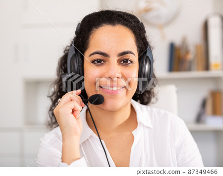 Happy call center operator talking with client at office 87349466