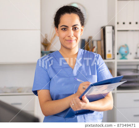 Woman is standing with documents in clinic 87349471