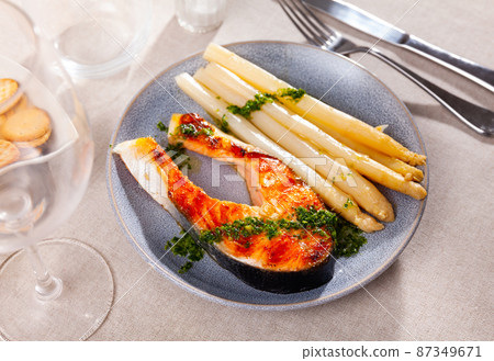 Grilled salmon steak with asparagus and pesto Grilled salmon steak with asparagus and pesto 87349671