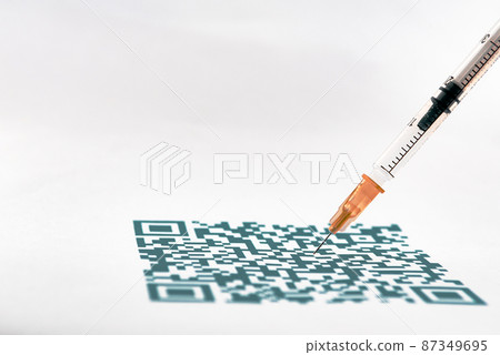 A QR code close up and medical syringe A QR code close up and medical syringe 87349695