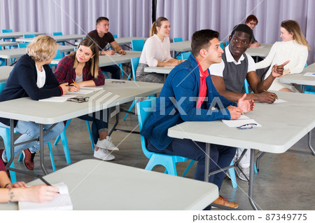 Adult students discussing lesson Adult students discussing lesson 87349775