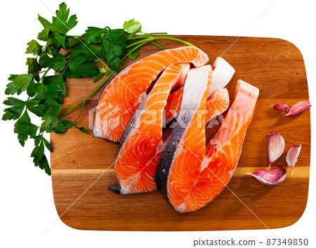 Raw salmon steaks with lemon, parsley, garlic 87349850