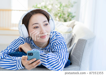 Headphones smartphone living room female Headphones smartphone living room female 87351355