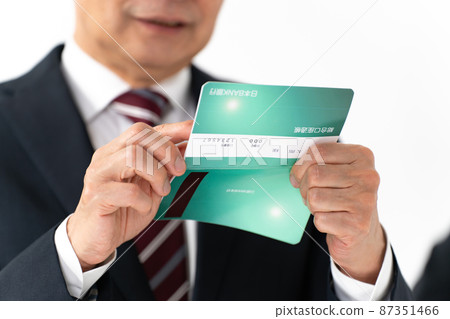 A businessman who is worried about looking at his passbook 87351466