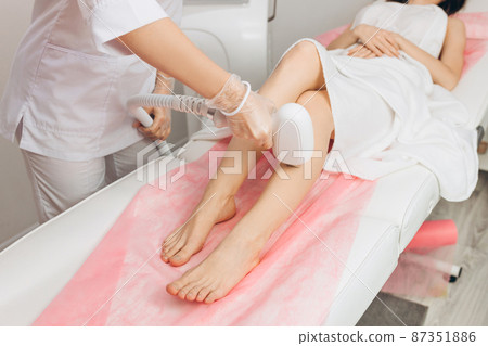 Hair removal on the legs, laser procedure at medical clinic. Beautiful smooth female legs in beauty salon, spa concept. Laser skin care banner Hair removal on the legs, laser procedure at medical clinic. Beautiful smooth female legs in beauty salon, spa concept. Laser skin care banner 87351886