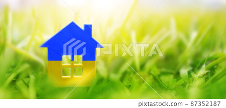 House model on the grass in urainian flag colours 87352187