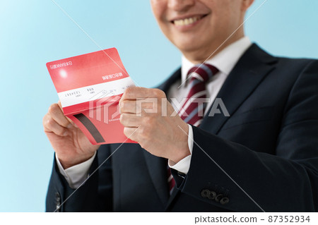 Senior businessman who is pleased to see the passbook Senior businessman who is pleased to see the passbook 87352934