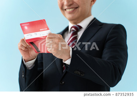 Senior businessman who is pleased to see the passbook Senior businessman who is pleased to see the passbook 87352935