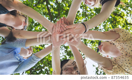 Group of female hands together in the park. 87354635