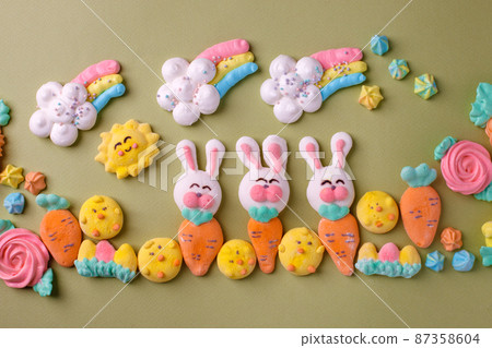 Sweets, pastry, gingerbread cookies for Easter table. Easter rabbit bunny, tender rainbow on green background top view copy space, spring seasonal holiday banner for your site, flyer, coupon 87358604