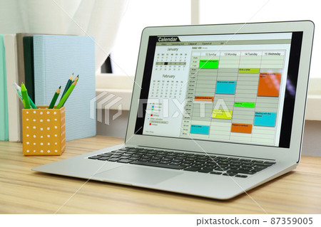Modern laptop with calendar on screen in office 87359005
