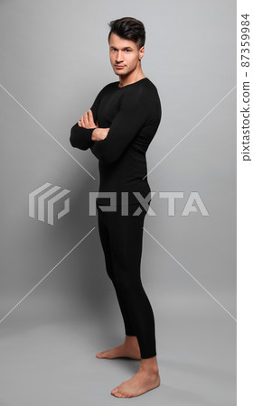 Man wearing thermal underwear on grey background Man wearing thermal underwear on grey background 87359984