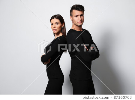 Couple wearing thermal underwear on light grey background 87360703