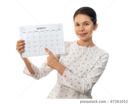 Young woman holding monthly calendar 87361052