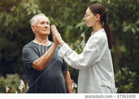 Happy elderly patient with helpful kind doctor 87361930