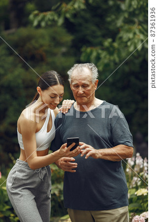 Portrait of happy handsome older man using smartphone Portrait of happy handsome older man using smartphone 87361936