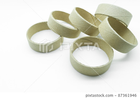 Narrow cardboard spools for winding rolled materials and self-adhesive labels. Reels made of cardboard for printing houses. Selective focus, isolated on white 87361946