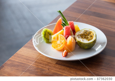 Fruit plate is on a wooden table, close up 87362030