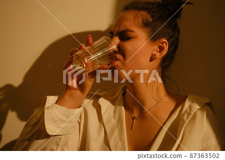young woman with alcohol 87363502