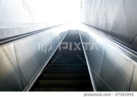 escalator leads somewhere to the light 87363948