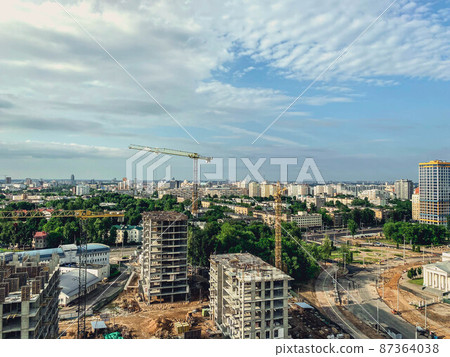 construction of a new neighborhood in the city. erection of new houses with a crane. high buildings for the life of people from concrete blocks construction of a new neighborhood in the city. erection of new houses with a crane. high buildings for the life of people from concrete blocks 87364038