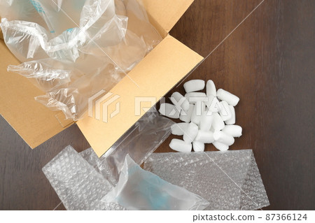 Lots of cardboard boxes and cushioning materials on the floor (overhead view) 87366124