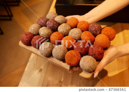 Belper Knolle cheese in the form of small balls. Small Swiss hard cheese balls Belper Knolle. Swiss cheese delicacy concept. Selective focus. 87366561