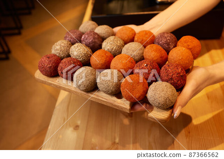 Belper Knolle cheese in the form of small balls. Small Swiss hard cheese balls Belper Knolle. Swiss cheese delicacy concept. Selective focus. 87366562