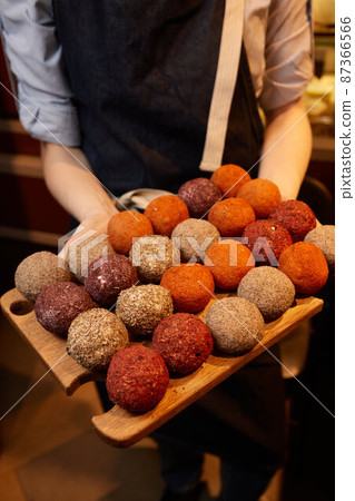 Belper Knolle cheese in the form of small balls. Small Swiss hard cheese balls Belper Knolle. Swiss cheese delicacy concept. Selective focus. 87366566